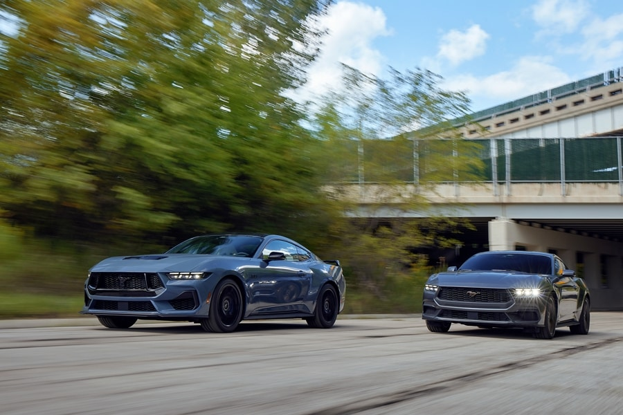Two 2025 Ford Mustang®s driving on a road