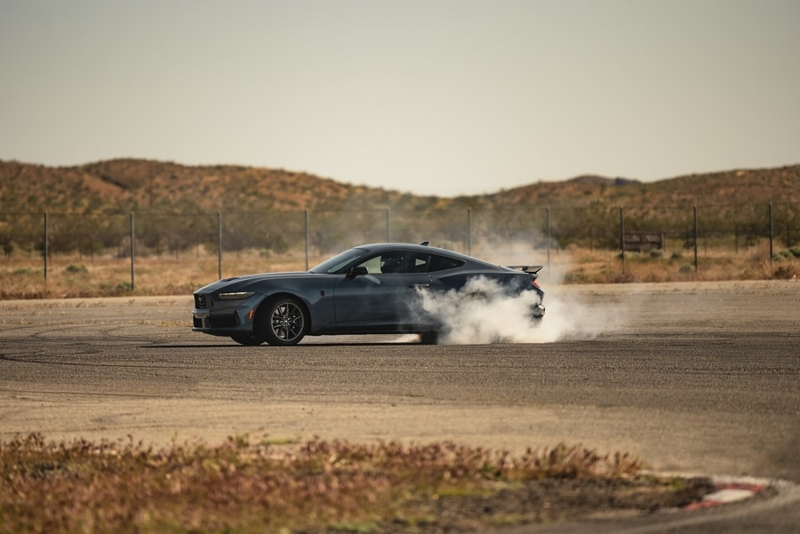 side view of a 2025 Ford Mustang® burning out on pavement
